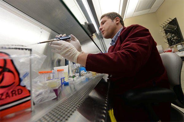 Dr. Matt Kay, a post-doctoral fellow at Naval Medical Research Unit-San Antonio, conducts an experiment to combat a drug-resistant infection at Joint Base San Antonio, Texas, Jan. 15, 2015. DoD photo by EJ Hersom  