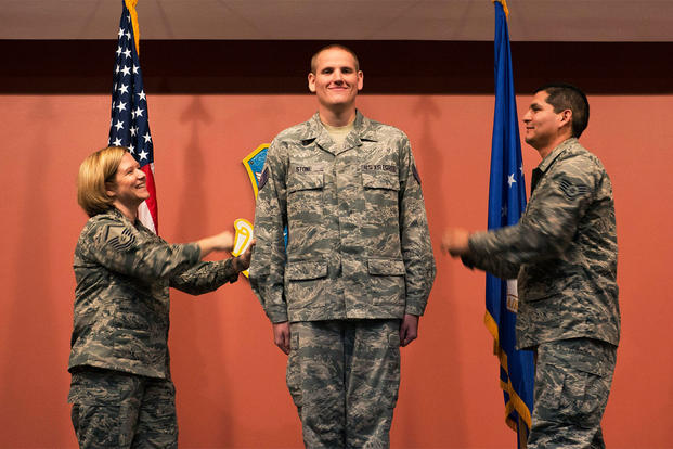 Master Sgt. Tanya Hubbard and Staff Sgt. Roberto Davila tack staff sergeant stripes onto Spencer Stone during a promotion ceremony at Travis Air Force Base, Calif., Oct. 30, 2015. (U.S. Air Force photo/T.C. Perkins Jr.) 