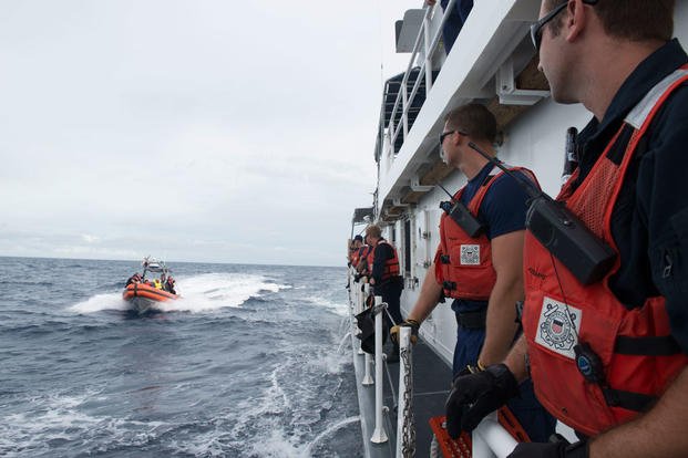 Crewmembers aboard the Coast Guard Cutter Kathleen Moore prepare to receive Cuban nationals interdicted in the Florida Straits, Dec. 7, 2015. (Photo: Petty Officer 3rd Class Ashley J. Johnson)