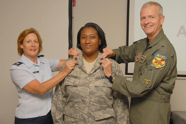 Cynethia Sheppard was promoted to the rank of Major on August 16, 2008. Pinning her is Lt. Col. Jody Jondo (left) and Brig. Gen. Guy Walsh (right). (U.S. Air Force photo by TSgt. Chris Schepers)