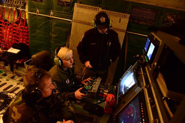 Petty Officer 3rd Class Shannon Fieste (center), Washington Department of Fish and Wildlife Officer Todd Deilman (top) and Oregon State Trooper Trygve Klepp monitor commercial fishing vessels Jan. 1, 2016. (Photo: Petty Officer 1st Class Levi Read)
