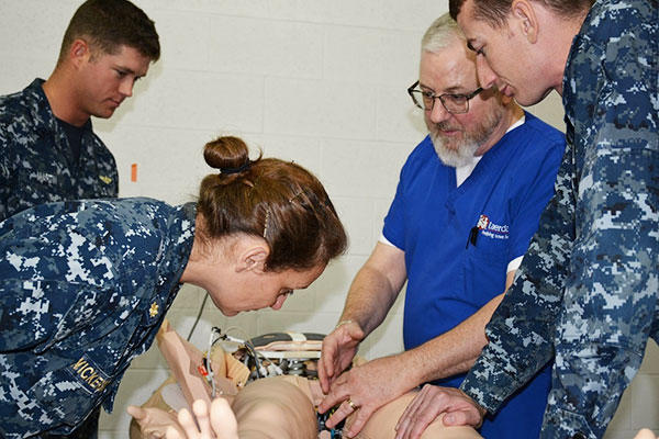 Mr. Scott McKee of Laerdal Medical, second from right, trains instructors on simulation equipment to be used in the Flight Medic Course (FMC) at the Naval Aerospace Medical Institution (NAMI). (U.S. Navy/HM2 Matthew Clutter)