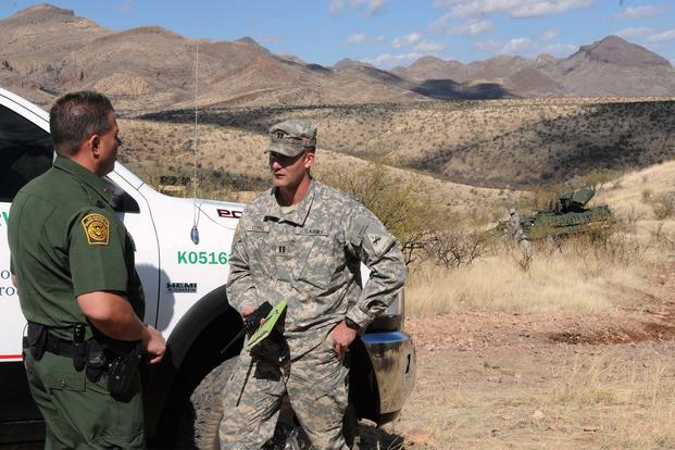 A U.S. Border Patrol Field Operations Supervisor, coordinates with Capt. Scott Young, commander from the 1st Armored Division, Fort Bliss, Texas on Feb. 27, 2012. (Photo Credit: Staff Sgt. Keith Anderson)