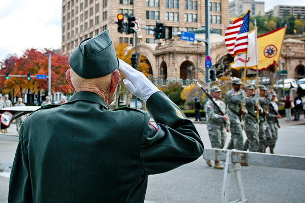Retired veteran saluting soldiers.