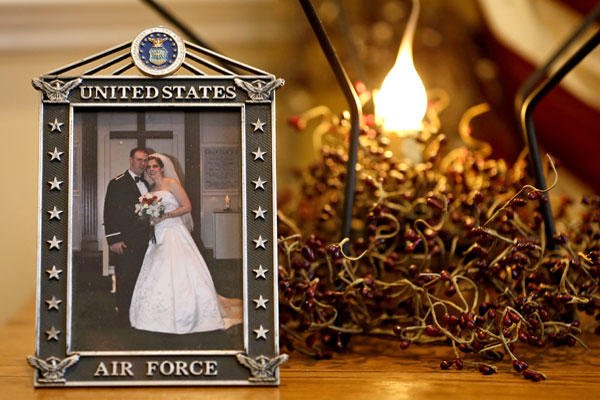 This Dec. 16, 2014, photo shows the wedding photo of Army widow, Aimee Wriglesworth, and her late husband, Chad, on display in her home in Bristow, Va. Wriglesworth lost her husband, an Army Major to cancer in 2013. Steve Helber/AP