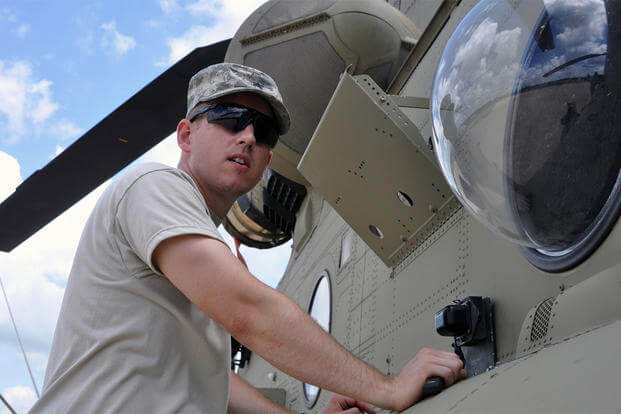 New York Army National Guard Sgt. Jared Twigg, a flight engineer, installs the Multiple Integrated Laser Engagement System (MILES) equipment on a CH-47 "Chinook" helicopter at Ft. Polk, La., Wednesday, July 13. (U.S. Army/Sgt. Maj. Corine Lombardo)