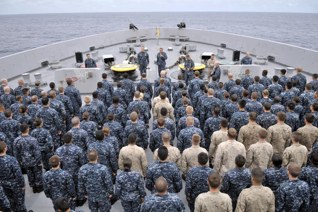 Sailors and Marines on the USS Green Bay during an all-hands call