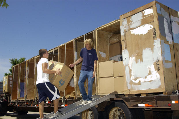 Movers at Scott Air Force Base, Illinois, load up a truck with household goods. Jose Ramirez/Air Force