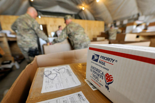 Airmen of the 455th Expeditionary Knowledge Operations Management office sort boxes and envelopes for personnel at Bagram Airfield, Afghanistan. (U.S. Air Force/Senior Airman Chris Willis.)