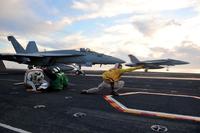 Lt. Cmdr. signals the launch of an F/A-18 Hornet from the flight deck of the aircraft carrier USS Ronald Reagan (CVN 76).. (U.S. Navy/Mass Communication Specialist 3rd Class Charles D. Gaddis)