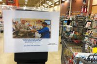 A sign at the Anchorage, Alaska area commissary notifies customers that certain lanes no longer offering bagging services. (Photo: Military.com)