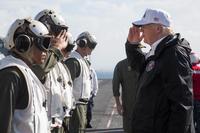 President Donald J. Trump, right, salutes Marines with the 26th Marine Expeditionary Unit, during his visit aboard the amphibious assault ship USS Kearsarge (LHD 3), Caribbean Sea, Oct. 3, 2017. (U.S. Marine Corps/Lance Cpl. Alexis C. Schneider)