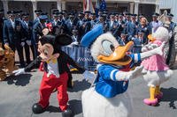 Disney characters run in front of a U.S. Air Force Honor Guard group photo at Disneyland in Anaheim, Calif., June 29, 2017. (U.S. Air Force/Jordyn Fetter)