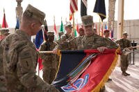 Maj. Gen. Walter Piatt, incoming commanding general of Combined Forces Land Component Command -- Operation Inherent Resolve and 10th Mountain Division and Fort Drum, New York, and Command Sgt. Maj. Samuel J. Roark uncase their division colors during the transfer of authority ceremony for the Combined Forces Land Component Command -- Operation Inherent Resolve in Baghdad, Iraq, March 19, 2018. (U.S. Army photo/Michael Reinsch)