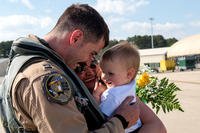 captain from the 336th Fighter Squadron greets his family after returning from deployment, April 11, 2018, at Seymour Johnson Air Force Base, North Carolina. Airmen from the 336th FS returned from a deployment in support of Operation Inherent Resolve. (U.S. Air Force/Shawna L. Keyes)