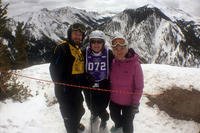 Army veteran Ted Wade, instructor Andrea Prudhomme, and Sarah Wade atop Snowmass Mountain during DAV's National Disabled Veterans Winter Sports Clinic.