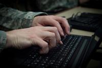 An Airman types on his computer at MacDill Air Force Base, Fla., March 9, 2018. (U.S. Air Force/Senior Airman Mariette Adams)