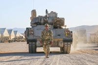 A U.S. Army Soldier assigned to 3rd Armored Brigade Combat Team, 1st Armored Division, Fort Bliss, Texas, ground guides an M2 Bradley Infantry Fighting Vehicle out of the Rotational Unit Bivouac Area prior to rollout during Decisive Action Rotation 18-08 at the National Training Center, Fort Irwin, Calif., June 1, 2018. (U.S. Army photo/Esmeralda Cervantes)