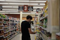 A customer at the base Commissary looks at food items July 13, 2017, on Columbus Air Force Base, Mississippi. (U.S. Air Force photo/Keith Holcomb)