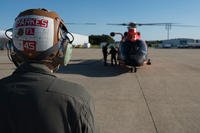 U.S. Marine Corps Sgt. Robert Parkes, Marine Medium Tilt Roader Squadron (VMM) 774 V-22 crew chief, poses in front of a U.S. Coast Guard Air Station Atlantic City HH-65 Dolphin on Coast Guard Air Station Atlantic City, N.J., June 14, 2018. The Marines conducted a forward air-refueling point for the first time – refueling an HH-65 with a VMM-774 V-22 Osprey. (U.S. Air Force photo/Ariel Owings)