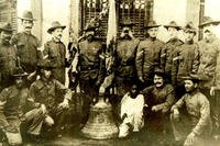 Soldiers from the 9th Infantry Regiment pose with one of three Balangiga bells in the Philippines in 1902 in this photo, displayed at the 2nd Infantry Division museum.
