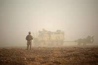 A Marine guides troop movement to a firing position in Syria. Military leaders were unable to determine whether a shooting there was an insider attack or negligent discharge. (Sgt. Matthew Callahan/Marine Corps)