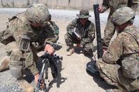 U.S. Army Sgt. Eric Chaffins and Spc. Richard Cazarez explain the set up and use of an M224 60 mm mortar system with bipod to Afghan National Army 1st Lt. Isaqh in Paktika province, Afghanistan, June 12, 2013. (U.S. Army courtesy photo)