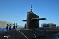 A crewmember of the Ohio-class guided-missile submarine, USS Florida (SSGN 728), heaves a line ashore as she arrives for a port visit on the island of Crete. (U.S. Navy/Paul Farley)