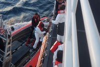 The crew of the Coast Guard Cutter Joseph Tezanos (WPC-1118) disembarks migrants from the cutter to transfer them for repatriation to the Dominican Republic, Thursday, Sept. 13, 2018. (U.S. Coast Guard photo)