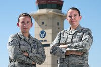 U.S. Air Force Tech. Sgt. Sarah Cartmill, right, 60th Maintenance Squadron and Staff Sgt. Kelsey Cartmill, 60th Air Mobility Wing, pose for a photo at Travis Air Force Base, Calif., September 25, 2018. The duel military same-sex couple has been married for five years. (U.S. Air Force/Louis Briscese)