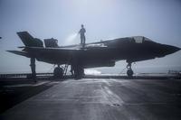 U.S. Marines with Marine Fighter Attack Squadron 211, 13th Marine Expeditionary Unit (MEU), wash an F-35B Lightning II aboard the USS Essex, September 4, 2018. (U.S. Marine Corps/Cpl. Francisco J. Diaz Jr.)