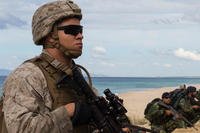 A U.S. Marine with the 26th Marine Expeditionary Unit holds security with Portuguese Marines at Praia Da Raposa beach in Portugal, during NATO's Trident Juncture exercise in October 2015. (US Army photo/Austin Long)