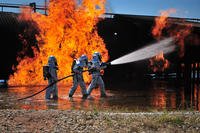 Firefighters work to extinguish a simulated engine fire at Cannon Air Force Base.