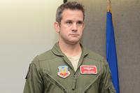 Maj. Adam Kinzinger stands as The Meritorious Service Medal award package is read during a ceremony at Truax Field, Madison, Wis., March 5, 2016. Kinzinger received the award for various mission accomplishments (U.S. Air National Guard/Staff Sgt. Andrea F. Rhode)