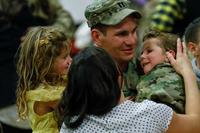 A captain assigned to 2nd Infantry Brigade Combat Team, 4th Infantry Division, embraces his children at a welcome home ceremony at the William &quot;Bill&quot; Reed Special Events Center at Fort Carson, Colorado., on Nov. 18, 2018. The Army is instituting a number of changes to ease child care, spouse employment and PCS issues. (U.S. Army photo by Capt. Daniel Parker)