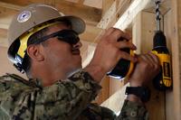 Construction Electrician Constructionman Alexander Ossorio, a Seabee from Los Angeles, drills a hole for electrical wiring at Marine Corps Base Camp Pendleton. (U.S. Navy/Chief Mass Communication Specialist Class William S. Parker)