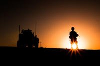 A Marine from 3rd Battalion, 3rd Marine Regiment, ground guides a vehicle into position near a temporary observation post in Southern Shorshork, Helmand province, Afghanistan, during the first day of Operation New Dawn, June 16, 2010. (U.S. Marine Corps photo/Mark Fayloga)