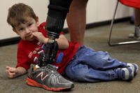 Kyle, 2, hangs out with Dad while eating a cookie during the Military Child Education Coalition's Tell Me a Story event at the Wounded Warrior Battalion's Warrior Hope and Care Center at Camp Pendleton April 30 (Sarah Wolff-Diaz, U.S. Marines)
