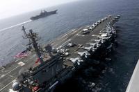 The USS Abraham Lincoln (CVN 72) and the Amphibious Assault Ship USS Kearsarge (LHD 3) conduct joint operations in the U.S. 5th Fleet area of operations. (U.S. Navy/Mass Communication Specialist 1st Class Brian M. Wilbur)