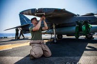 U.S. Marine Corps Sgt. Johnathan Davis, an AV-8B Harrier airframe mechanic assigned to Marine Medium Tiltrotor Squadron (VMM) 266 (Reinforced), 26th Marine Expeditionary Unit (MEU), performs general maintenance on his aircraft on the flight deck of the USS Kearsarge (LHD 3), at sea, July 20, 2013. (U.S. Marine Corps photo/Christopher Q. Stone)