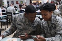 Airmen look at smartphones in a screengrab from a military PSA video about FaceApp (Screenshot via DVIDS)