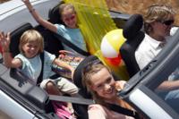 A family rides in a convertible