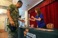 Master Chief Master-at-Arms David Aguilera speaks with an Amazon representative at Fleet and Family Support Center Yokosuka’s job fair in Yokosuka, Japan.