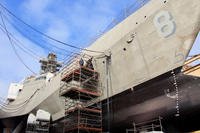 Shipyard workers perform upgrades on the forward mooring station onboard Independence variant littoral combat ship USS Montgomery (LCS 8), July 28, 2017. (U.S. Navy photo/Adam Ross)