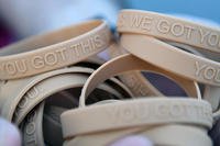 Bracelets, labeled with the message, &quot;You Got This. We Got You,&quot; are handed out to participants during the Dragon March on Keesler Air Force Base, Mississippi, Sept. 13, 2019. (U.S. Air Force/Kemberly Groue)