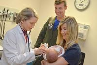 Navy Lt. Jacob Balesi, a flight officer with Patrol Squadron Thirty, and his family visit Naval Hospital Jacksonville's pediatrics clinic. (U.S. Navy/Jacob Sippel)