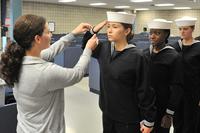 Navy recruits are fitted in their dress blue jumper top, traditionally known as the “Crackerjack.” 