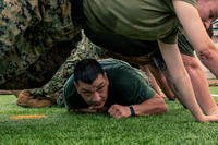 A Marine low crawls during PT.
