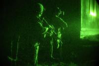 Marines Raiders lead a simulated night raid training exercise.