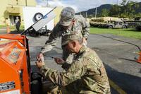 Puerto Rico Air National Guard, perform maintenance on a generator for the Joint Incident Site Communications Capability trailer at the command and control center in Cayey, Dec. 27, 2019.. (U.S. Army/Master Sgt. Caycee Watson)